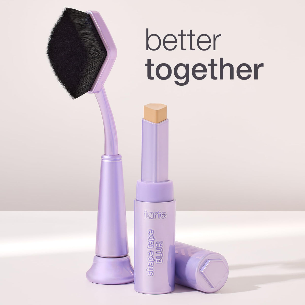 tarte brush next to concealer stick showing size and compatibility