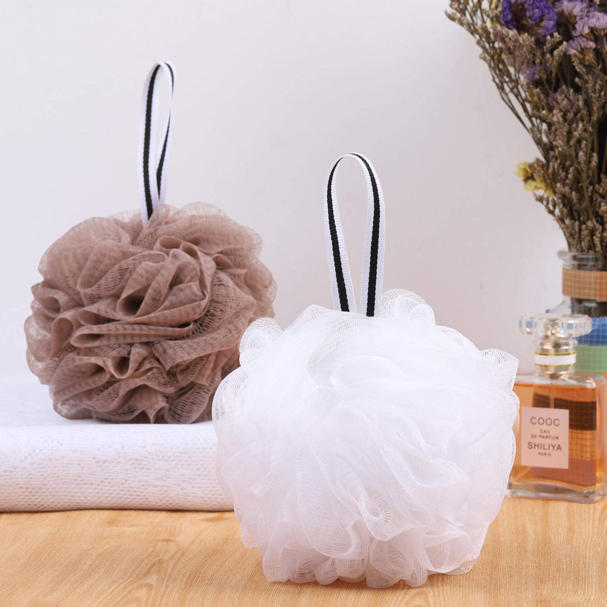 Tbestmax pouf held in hand demonstrating 5.5-inch comfortable size
