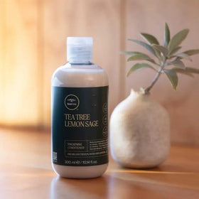 Tea Tree being applied to mid-lengths to ends demonstrating detangling effect