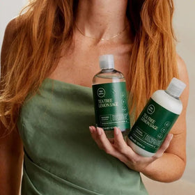 Tea Tree in-shower use with hand applying conditioner for detangling and volume
