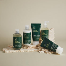 Tea Tree bottle on bathroom counter suggesting daily styling use and fresh scent