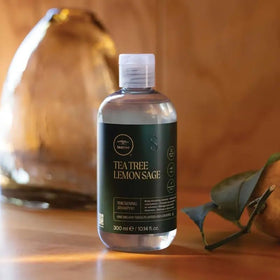 Tea Tree 33.8 fl oz bottle beside common items for scale and value