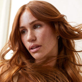 Tea Tree product in use during blow-dry giving visible root lift and volume