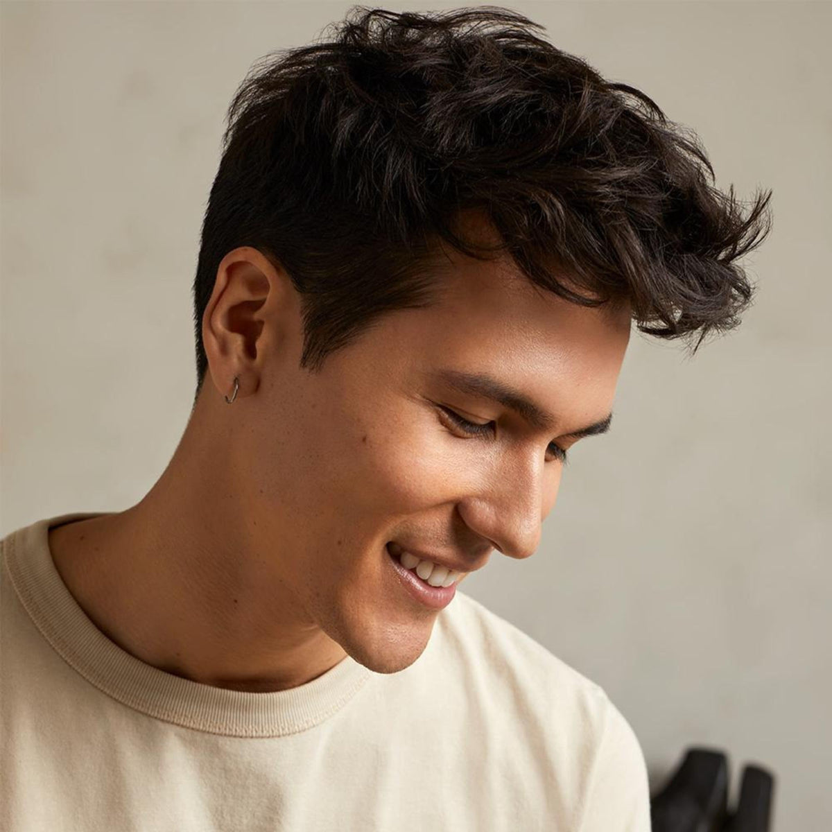 Tea Tree pomade on hands demonstrating smooth application and controlled styling