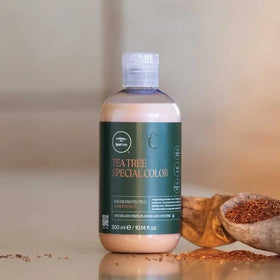 Tea Tree size comparison in hand showing 10.14 fl oz travel-friendly benefit