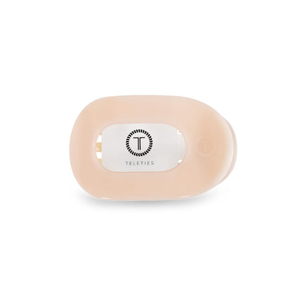 TELETIES flat round clip front view showing compact almond beige design and comfortable hold