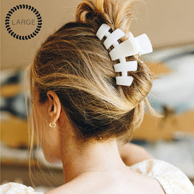 TELETIES clip securing a thick hair updo for reliable all-day wear