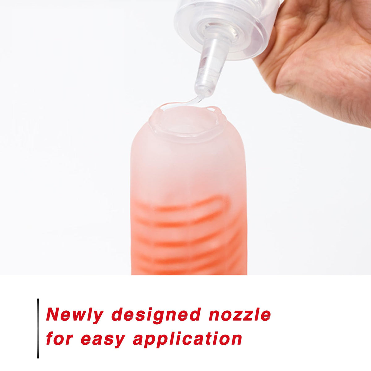 Hand holding TENGA Red bottle to show grip and easy targeted application benefit