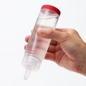 TENGA Red lotion pouring to show silky texture for smooth glide benefit