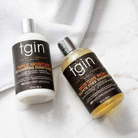 Thank God It's Natural conditioner being applied for gentle detangling benefit