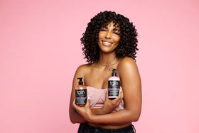 tgin duo in hand size comparison showing travel-friendly 13 oz bottles benefit