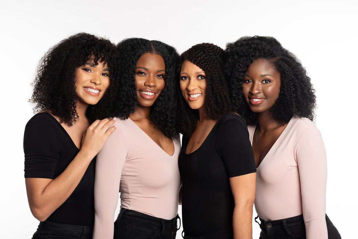 tgin product being applied to wet curly hair showing gentle cleansing in use