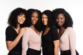 tgin product being applied to wet curly hair showing gentle cleansing in use