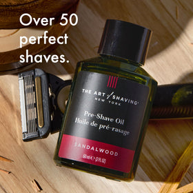 Hand holding the 2 oz The Art of Shaving bottle to show scale and travel-friendly benefit