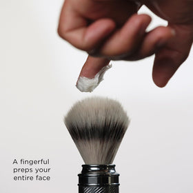 The Art of Shaving lavender shaving cream worked into lather on hand for easy application