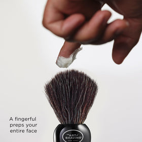 The Art of Shaving 2.5 oz tube next to razor showing compact travel-friendly size