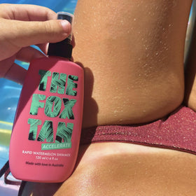 THE FOX TAN bottle next to a hand showing compact 120 mL travel size