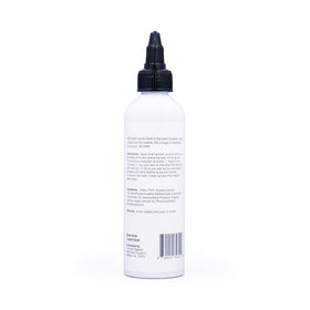 Person styling baby hairs in a mirror using The Hair Diagram gel for polished, wearable results