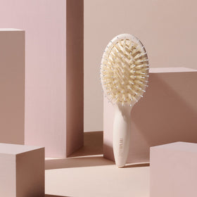 The Hair Edit brush tucked in a travel pouch for on-the-go touch-ups and protection