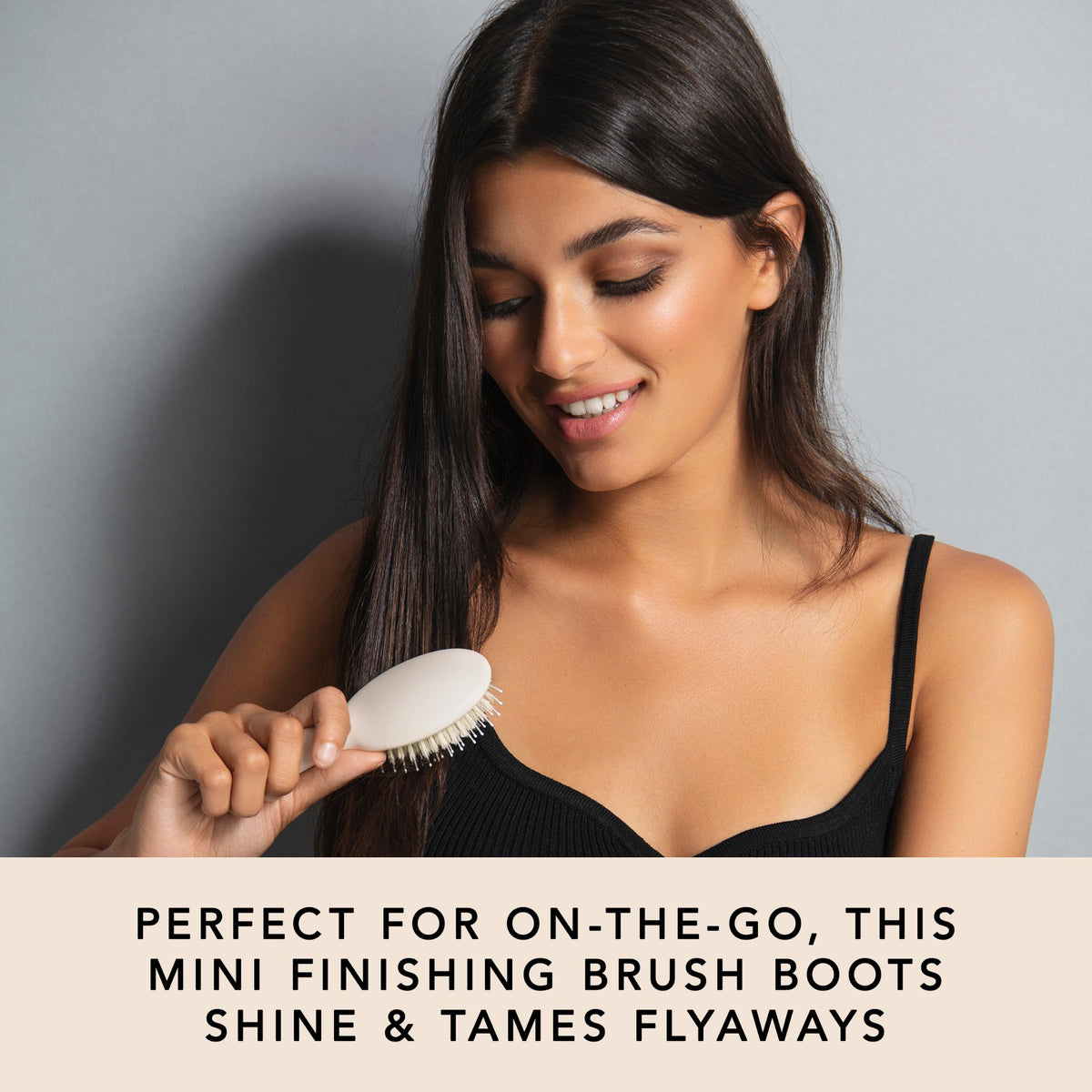 The Hair Edit brush held in hand to show size and easy portability benefit