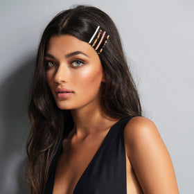 The Hair Edit marble bobby pins in hand for scale showing slim profile and lightweight comfort