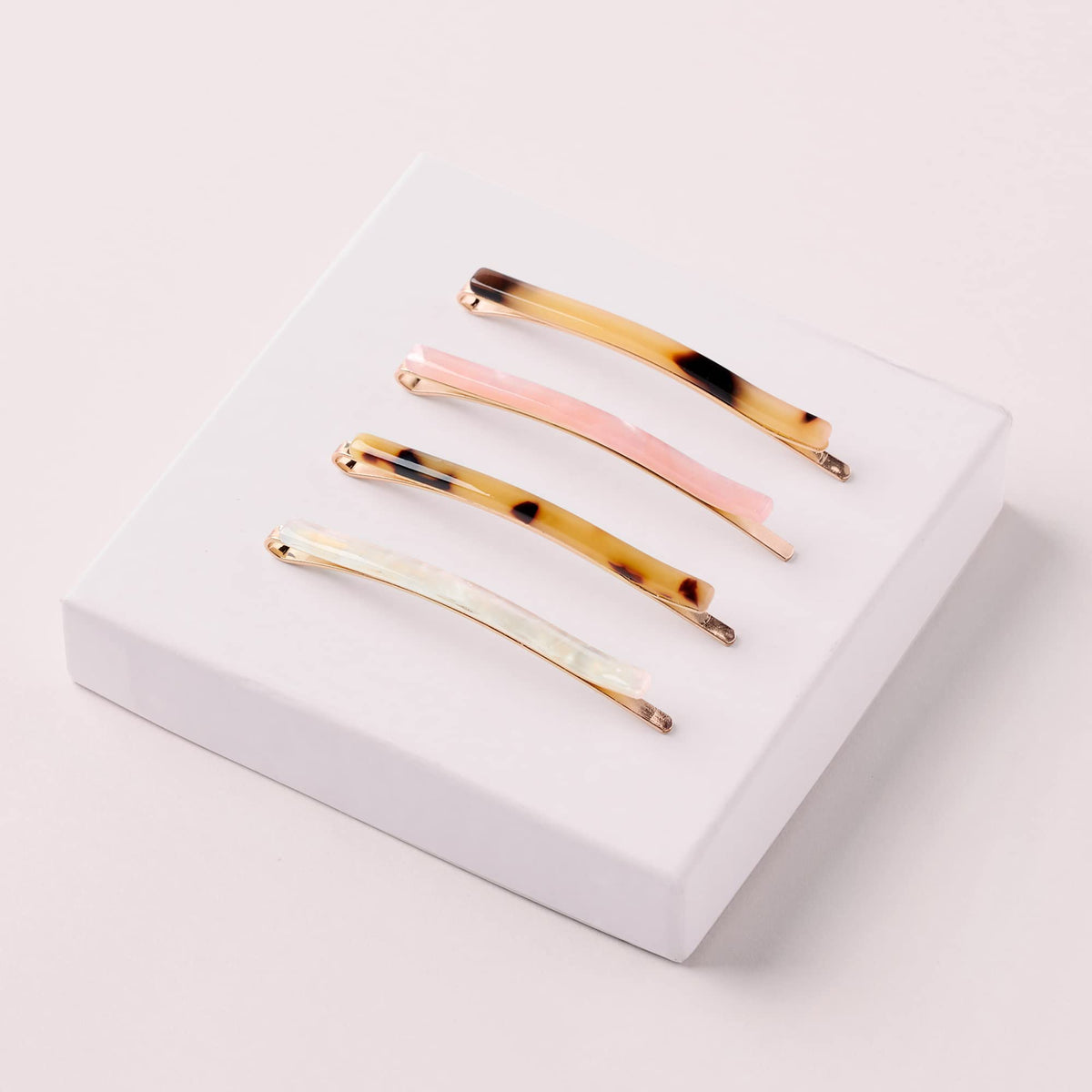The Hair Edit marble bobby pins on model styled to show decorative hold and polished look