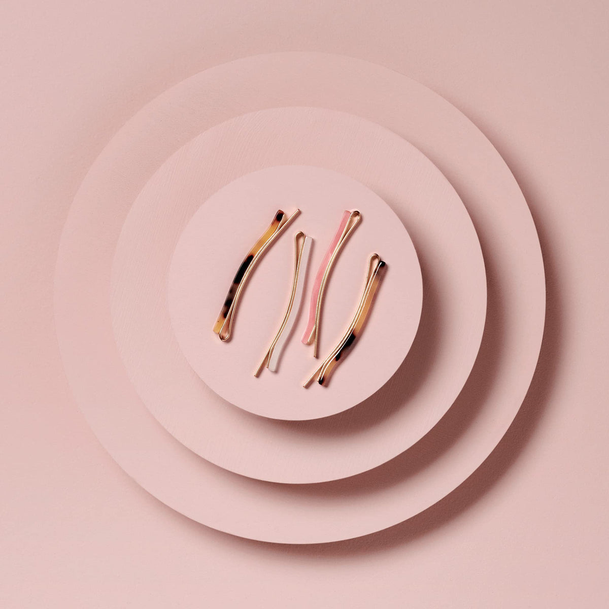 The Hair Edit marble bobby pins packaging flat lay showing four-pack convenience and storage