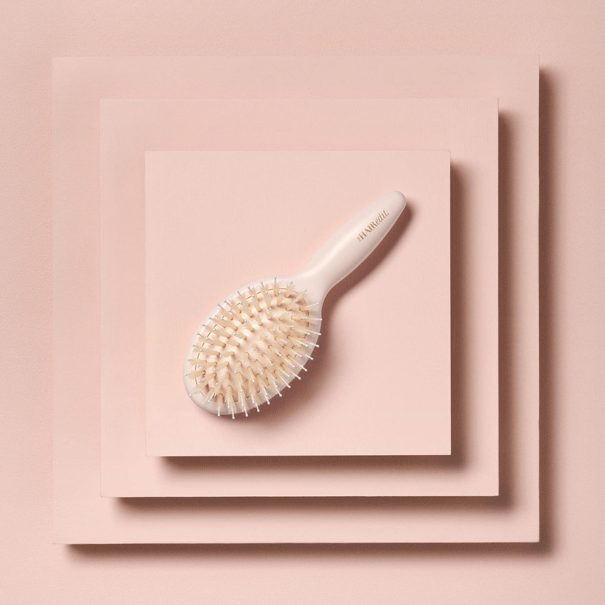 The Hair Edit brush smoothing flyaways on dry hair for polished, frizz-free finish