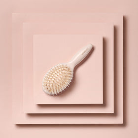 The Hair Edit brush smoothing flyaways on dry hair for polished, frizz-free finish