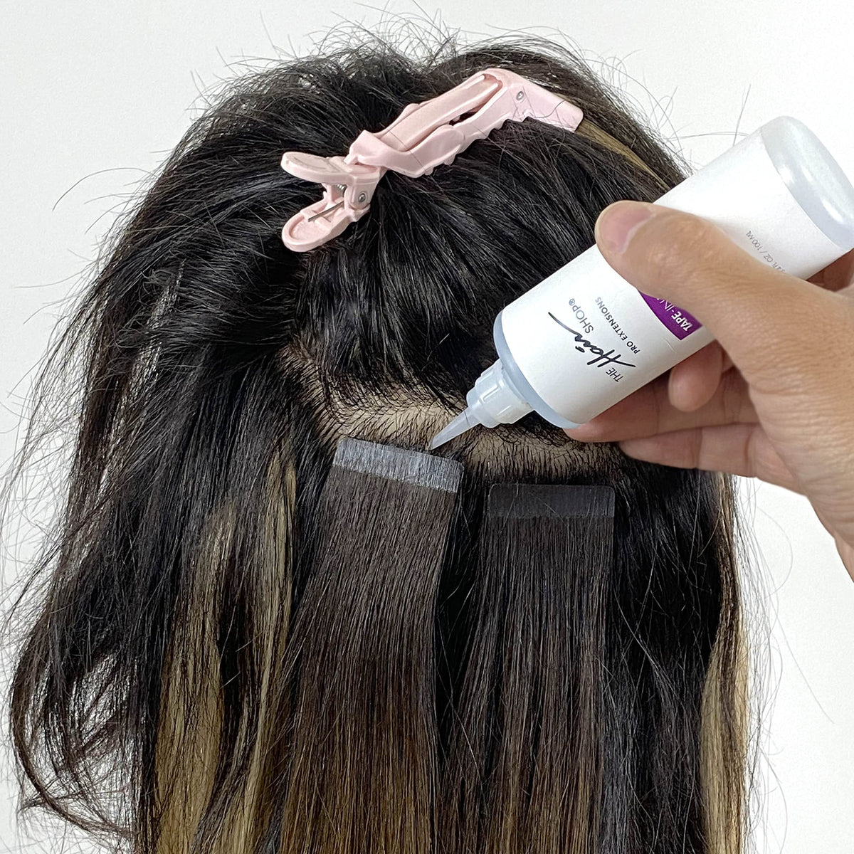 The Hair Shop product in salon use easing tape-in removal process