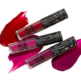 Hand holding The Lip Bar mini trio to show scale and travel-friendly portability