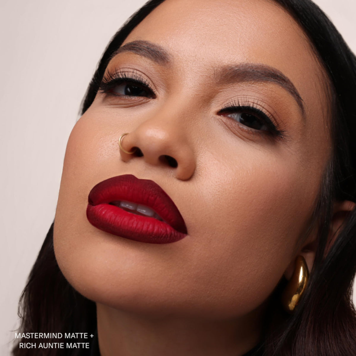 Clear shot of ingredients label on The Lip Bar tube highlighting jojoba oil and vitamin E benefit