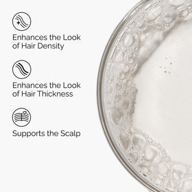 The Ordinary applying serum to scalp, demonstrating targeted use for denser-looking hair