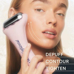 The Skinny Confidential roller beside hand for size comparison and quick full-face coverage