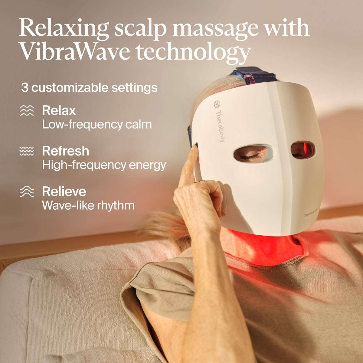 TheraFace Mask Glo beside smartphone for scale to show compact, portable size