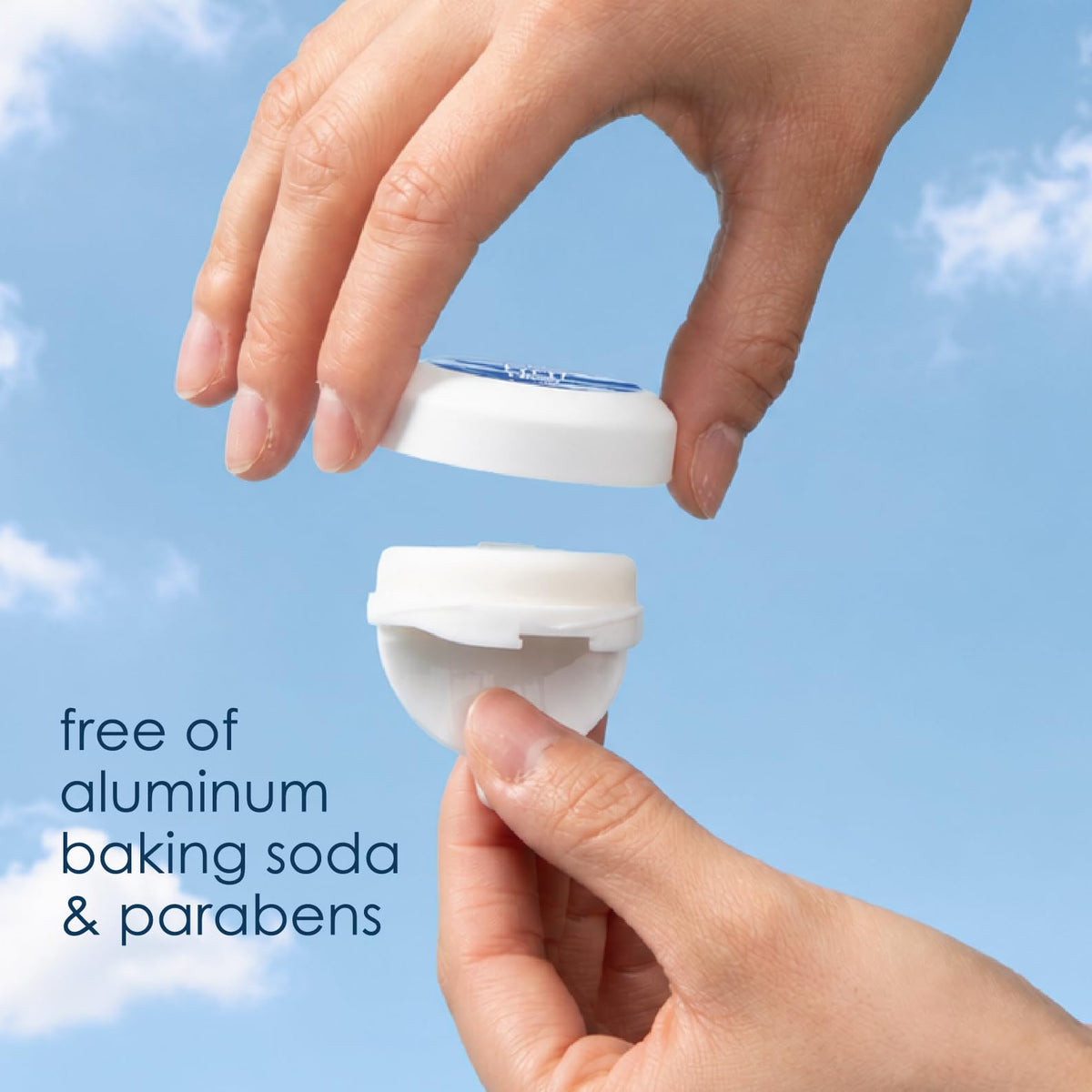 TINI stick next to a hand for scale showing travel-size convenience