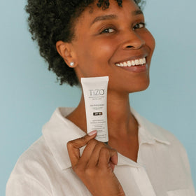 TIZO tube in hand to show product size and travel-friendly convenience