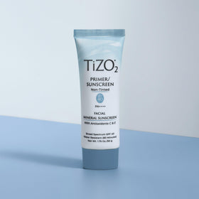 TIZO tube held in hand to show TiZO2 size and travel-friendly convenience