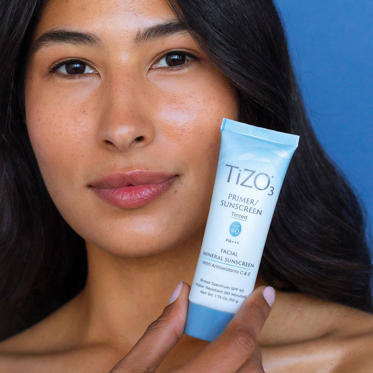TIZO tube next to ruler to show 1.75 oz size and travel-friendly benefit
