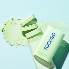 TOCOBO applying sun stick to cheek for targeted cooling and coverage