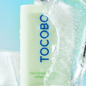 TOCOBO sun stick placed on beach towel showing outdoor protection benefit
