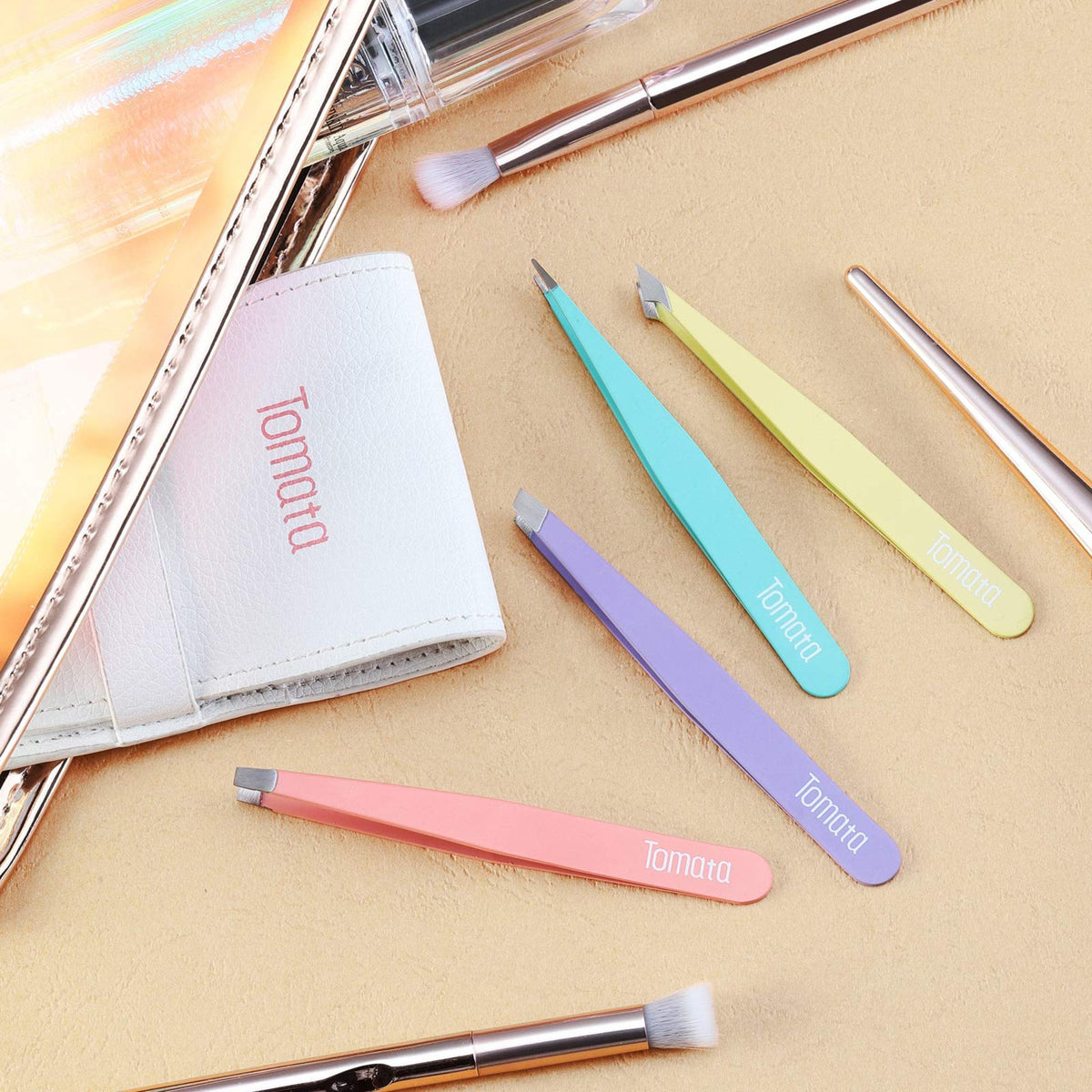 Tomata tweezers held by a finger to show real-life size and precision