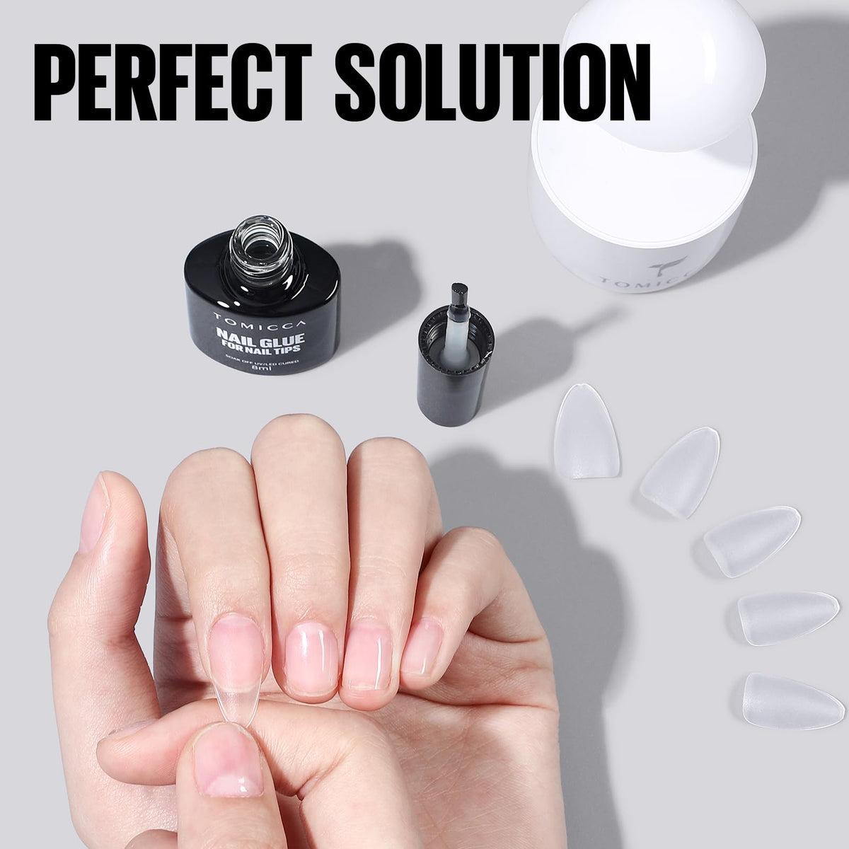 TOMICCA 8ml tube next to a coin showing compact travel-friendly size