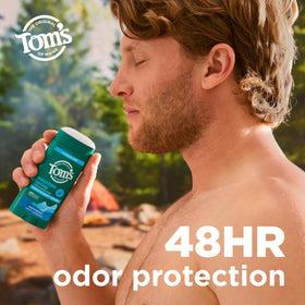 Tom's of Maine applying deodorant to underarm for fresh confidence