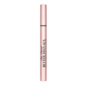 Too Faced eyeliner in a makeup bag by a mirror for on-the-go convenience