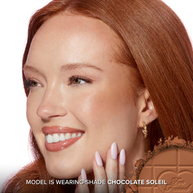 Too Faced bronzer being swept with brush for natural blended warmth