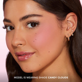 Too Faced compact beside common items to show travel-friendly size and portability benefit