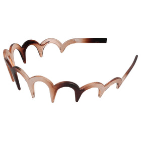 TOSEFES headbands next to hand to show compact size and lightweight feel