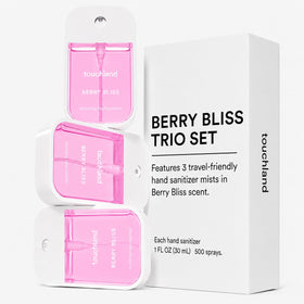 Touchland Berry Bliss mist spraying on hands demonstrating quick, even coverage