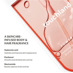 Touchland being spritzed on hair illustrating softness and light fragrance